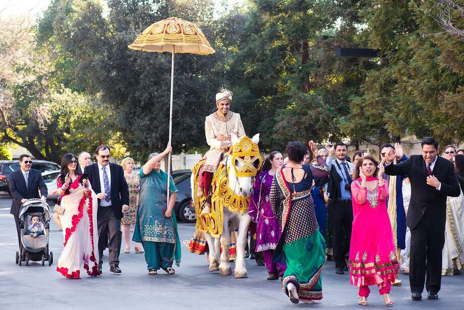 Abe Gupta rides a horse into the wedding on a horse, per tradition. He and bride Vaishali Bhatnagar got married during a six-day affair, with the traditional Hindu ceremony taking place at San Joses Hayes Mansion. Photo: Janet Love Photography
