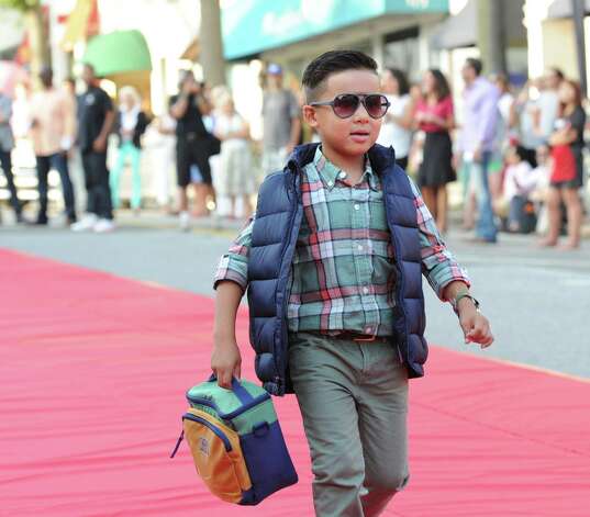Last year’s “Fashion on the Avenue” event on Greenwich Avenue took place Sept. 5. Dozens of models of all ages took to the outdoor red carpet to put on a runway show featuring top fashions from local retailers and designers. Photo: Bob Luckey / File Photo / Greenwich Time