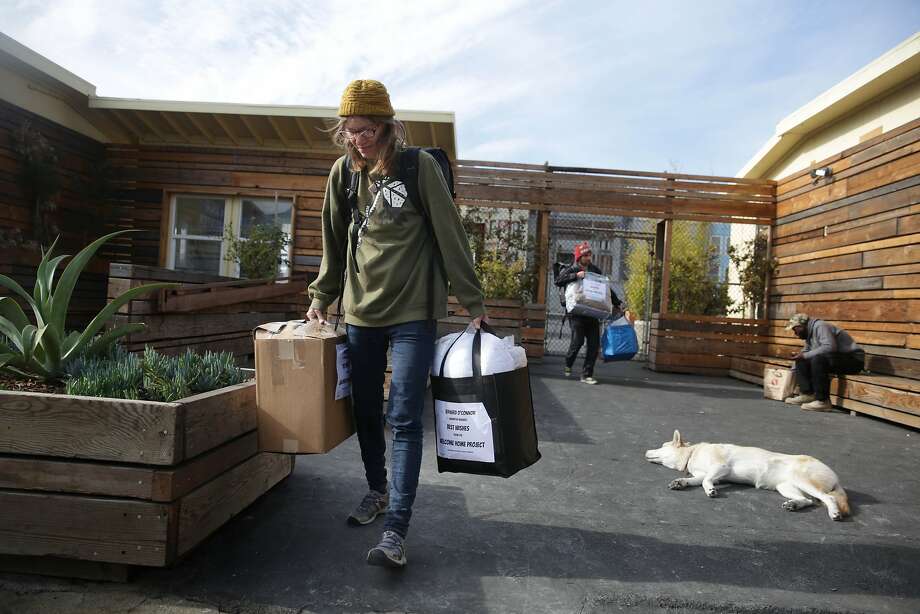 Barbara McHenry (left), who moved to her new room on November 4, after living at the Navigation Center for 2 months, collects some of the last of her belongings from the Navigation Center with her partner Bernard Thomas O'Connor Jr.(second from left), who also got a room,  on Wednesday, December 2,  2015 in San Francisco, Calif. Photo: Lea Suzuki, The Chronicle