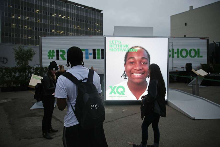 Amir Williams (foreground), junior Oakland High School, looks at his image projected on the XQ We Think booth during an XQ roadshow event at Broadway and 8th Street on Wednesday, December 9,  2015 in Oakland, Calif. Photo: Lea Suzuki, The Chronicle