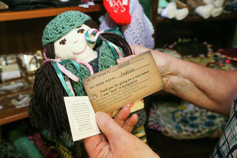 Jean Sherrill, business manager for the Center for Refugee Service's World Mosaic Market, 8703 Wurzbach, holds a handmade doll made in Kyrgystan on Friday, Dec. 11, 2015.  MARVIN PFEIFFER/ mpfeiffer@express-news.net Photo: Marvin Pfeiffer, San Antonio Express-News / Express-News 2015