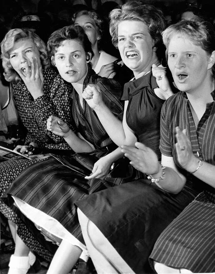 Fans watch Elvis Presley perform at the Sam Houston Coliseum in Houston.  October 13, 1956. Photo: Keith Hawkins, Chronicle File / Houston Post files