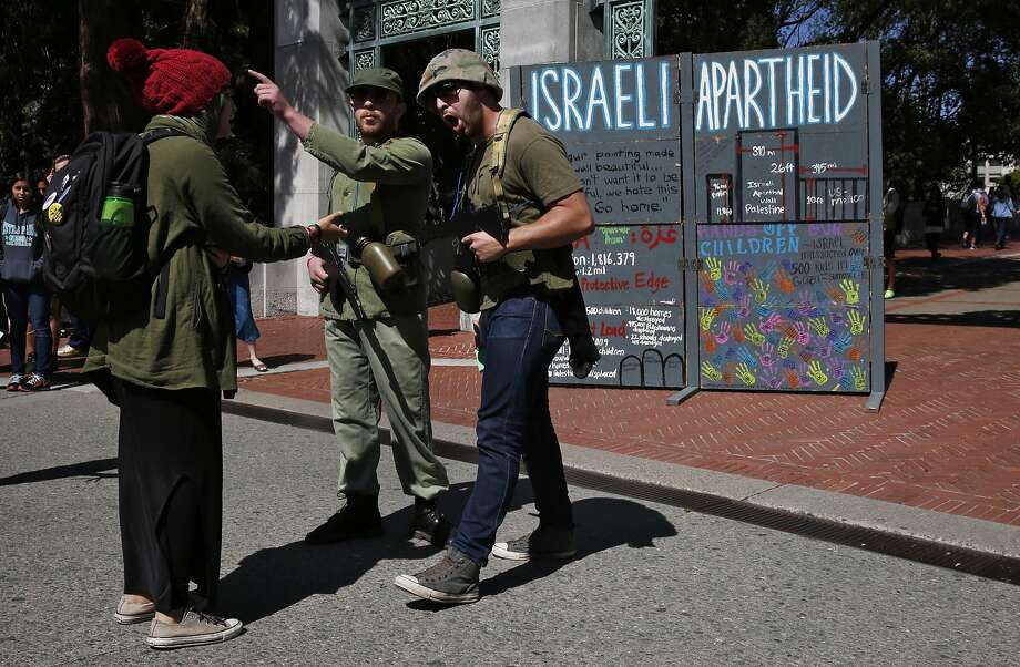 Protesters who preferred not to give their names role play as Israeli soldiers with a person role playing a Palestinian during a mock Israeli check-point demonstration near the Sather Gate on the University of California, Berkeley campus March 29, 2016 in Berkeley, Calif. The event was sponsored by Students for Justice in Palestine and was part of a week of events meant to raise awareness about the Palestinian situation. Photo: Leah Millis, The Chronicle