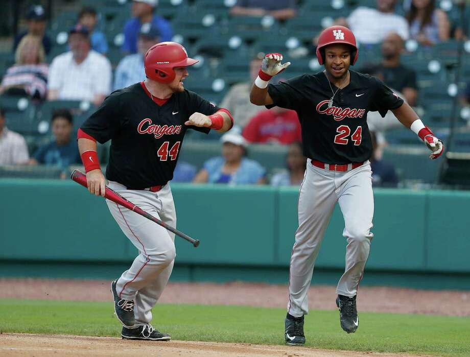 Houston infielder Corey Julks (24) celebrates his run scored with Joe Davis (44) on Houston's Jacob Campbell's two-run single during the fourth inning of a college baseball game at Constellation Field Tuesday, May 17, 2016, in Sugar Land. Photo: Karen Warren, Houston Chronicle / © 2016 Houston Chronicle