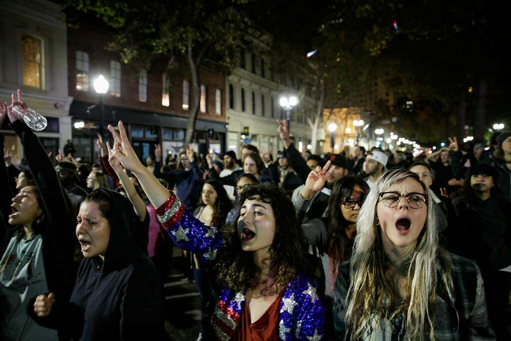 Demonstrators Madeline Lopes (center) and Cassidy Irwin (right) protested against president-elect Donald Trump in Oakland, California, U.S., November 9, 2016. Another group earlier in the night set fire to garbage bins and smashed multiple windows. Photo: Gabrielle Lurie, The Chronicle