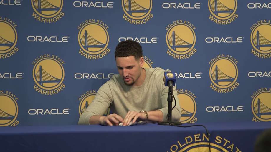 Klay Thompson folds a paper airplane after a press conference on Nov. 28.