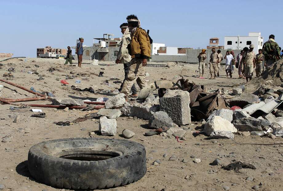 Soldiers gather last Sunday at the site of a suicide bombing at a base in the southern city of Aden. Photo: Wael Qubady, Associated Press