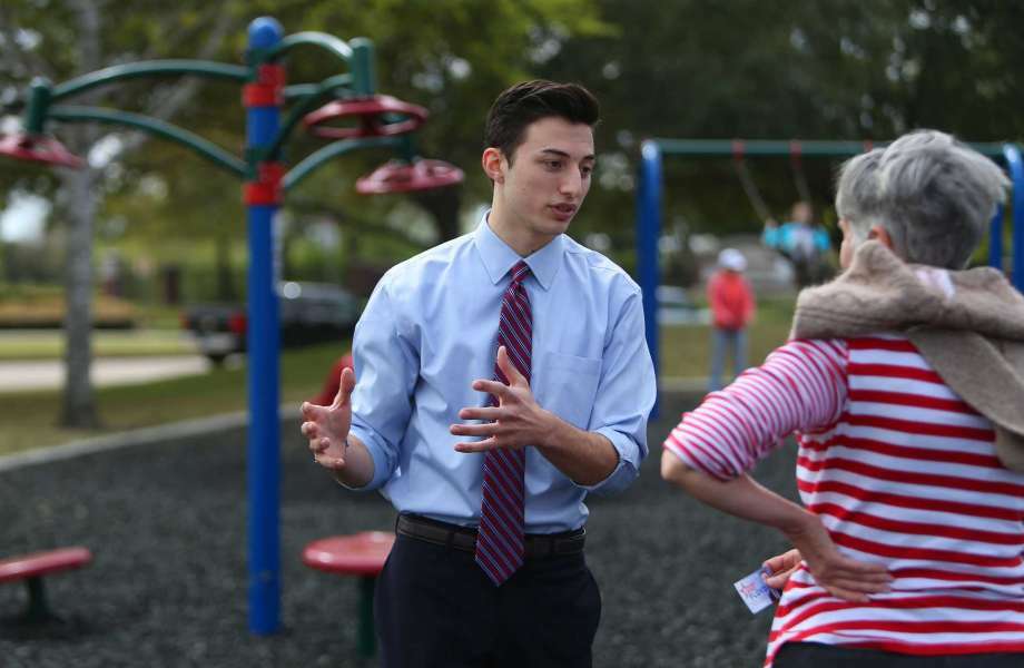 Mike Floyd, an 18-year-old senior at Dawson High School, speaks to a potential voter about his run for the Pearland Independent School District's Board of Trustees, Wednesday, March 15, 2017, at Silverlake Park.