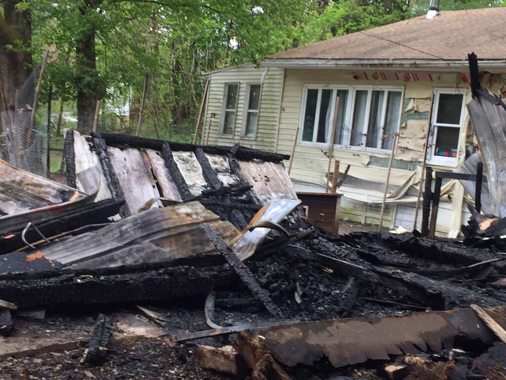A black family woke up Sunday night to find their detached garage sprayed with hateful graffiti and engulfed in flames, town police Schodack Chief Joseph Belardo said Monday. The parents and their five children — who are all under the age of 10 — were physically unharmed but emotionally traumatized by the fire set at 29 Cold Spring Ave., the chief said. A black family woke up Sunday night to find their detached garage sprayed with hateful graffiti and engulfed in flames, Schodack Police Chief Joseph Belardo said Monday, May 15, 2017. The parents and their five children — who are all under the age of 10 — were physically unharmed but emotionally traumatized by the fire set at 29 Cold Spring Ave., the chief said. (Robert M. Gavin/Times Union) Photo: Robert Gavin