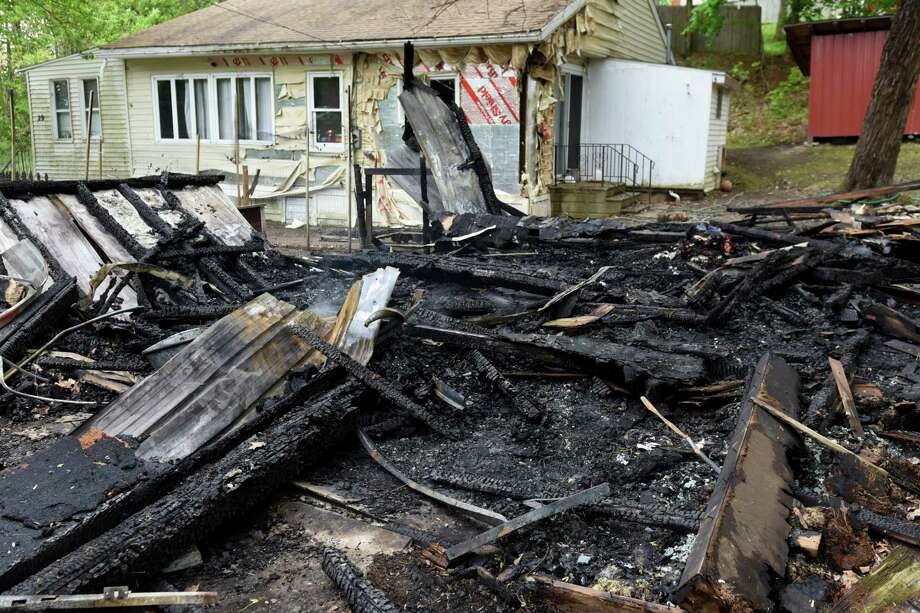 The smoldering remains of a building on Cold Spring Road on Monday, May 15, 2017, in Schodack, N.Y. Authorities said someone set fire to the structure on Sunday and the fire is considered a hate crime. Schodack police do not identify the race or religion of the homeowners but a source says the victims are black. (Will Waldron/Times Union) Photo: Will Waldron / 20040517A