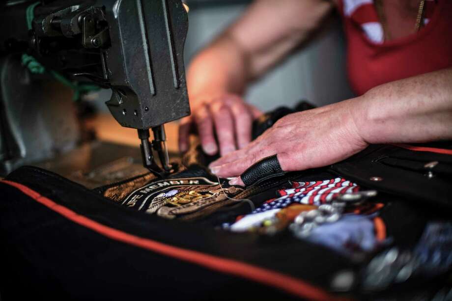 Cindy DiCarlo, of North Beach, Maryland, sews a new patch onto a biker vest Saturday at Harley Davidson of Washington, D.C., in Fort Washington, Maryland. Must credit: Photo by J. Lawler Duggan for The Washington Post Photo: J. Lawler Duggan, For The Washington Post / J. Lawler Duggan