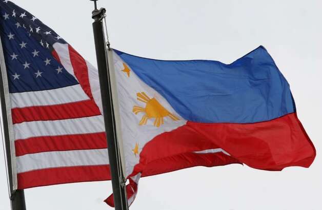 The Filipino flag flies next to the American flag during a flagraising 