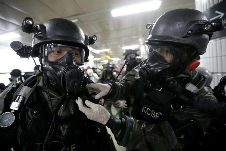 Army soldiers checks their gas masks during an antiterror drill in a Seoul subway station