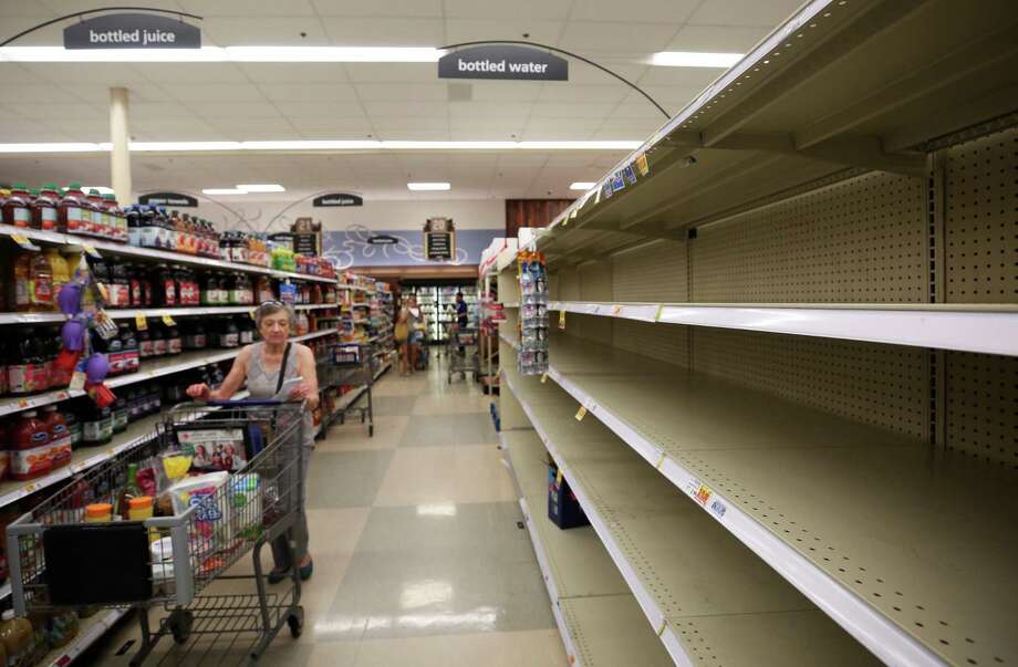 Consumers found empty shelves Thursday in the bottled water section at the Kroger on Buffalo Speedway. The store is expecting truckloads of water today before Harvey reaches landfall. Photo: Godofredo A. Vasquez, TSHarveyPrep / Houston Chronicle