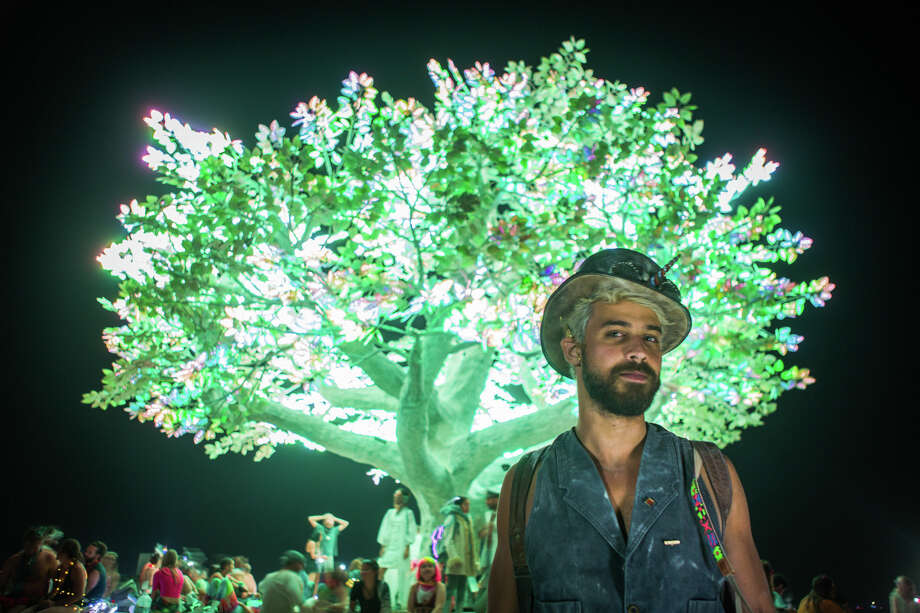 Raul Aragao from Brazil in front of the Tree of Ténéré at Burning Man 2017, the largest outdoor arts festival   in North America, in the Black Rock desert of Gerlach, Nevada. ("Sidney Erthal works with the Burning Man Project as an archivist, photographer, and translator.") Photo: Sidney Erthal / Burning Man
