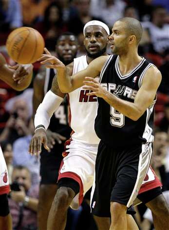 San Antonio Spurs' Tony Parker (9) passes the ball as Miami Heat's LeBron James, left, looks on during the first half of an NBA basketball game, Tuesday, Jan. 17, 2012, in Miami. (AP Photo/Lynne Sladky) Photo: Associated Press