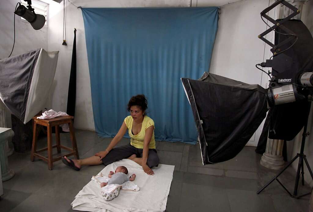 Jennifer Benito-Kowalski takes baby Kyle to get his first passport at a photo studio in Anand, India, Friday, May 31, 2013. Photo: Nicole Fruge, The Chronicle