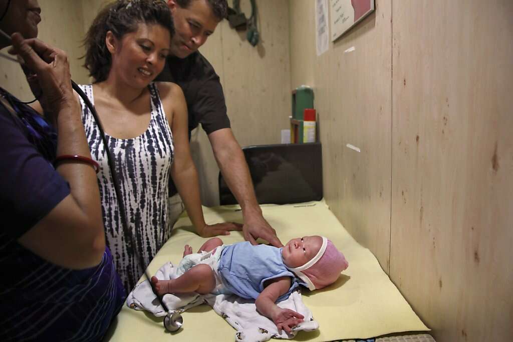 Jennifer Benito-Kowalski and Steve Kowalski take their baby Kyle Benito Kowalski to his first pediatrician's appointment before he is released from the Apara Nursing Home in Anand, India, Friday, May 24, 2013. Photo: Nicole Fruge, The Chronicle