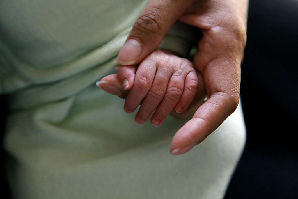 Jennifer Benito-Kowalski holds baby Kyle's hand at the Madhubhan Resort and Spa in Anand, India, Tuesday, May 28, 2013. Photo: Nicole Fruge, The Chronicle