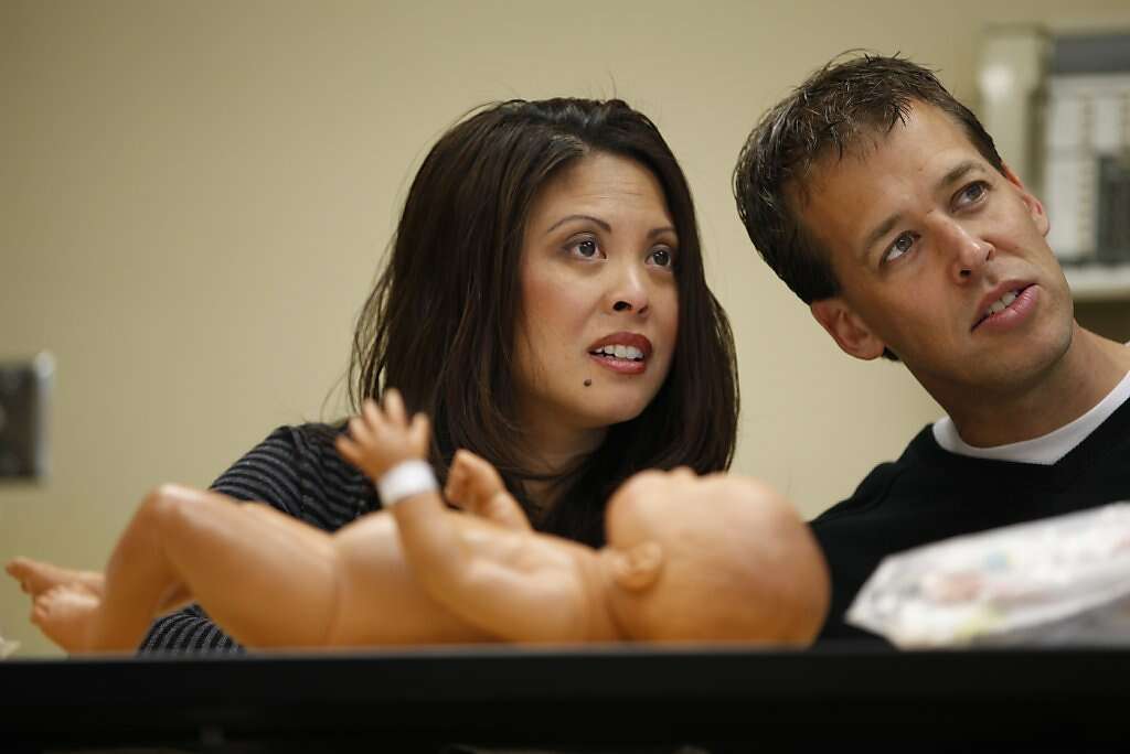 Jennifer Benito-Kowalski and Steve Kowalski attend a newborn care class at Kaiser Permanente in Redwood City, Calif., on Saturday, Jan. 19, 2013. Benito-Kowalski tried to conceive a child, but at 38 she worried she'd never be a mother. Ultimately, the Kowalskis would pay a surrogate in India to carry their child, who was born in May. Photo: Nicole Fruge, The Chronicle