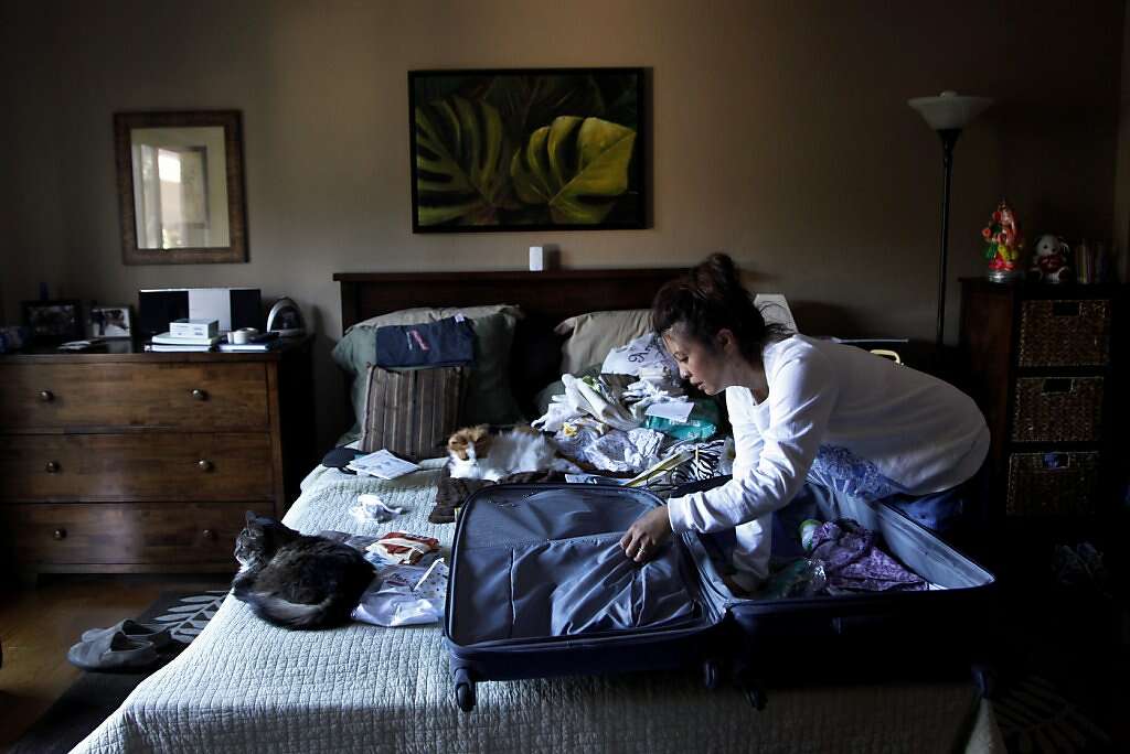 Jennifer Benito-Kowalski unpacks in her San Carlos, Calif., home after a 3 1/2-week trip to India on Saturday, June 15, 2013. Photo: Nicole Fruge, The Chronicle