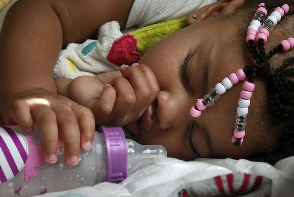 LaMya Deshana Price naps before her first birthday party at Chuck E. Cheese's, Saturday, November 9, 2013, in Hayward, Calif. LaMya was born November 8, 2012, just nine months after her uncle Lamont DeShawn price was shot and killed in east Oakland. Photo: Lacy Atkins, The Chronicle