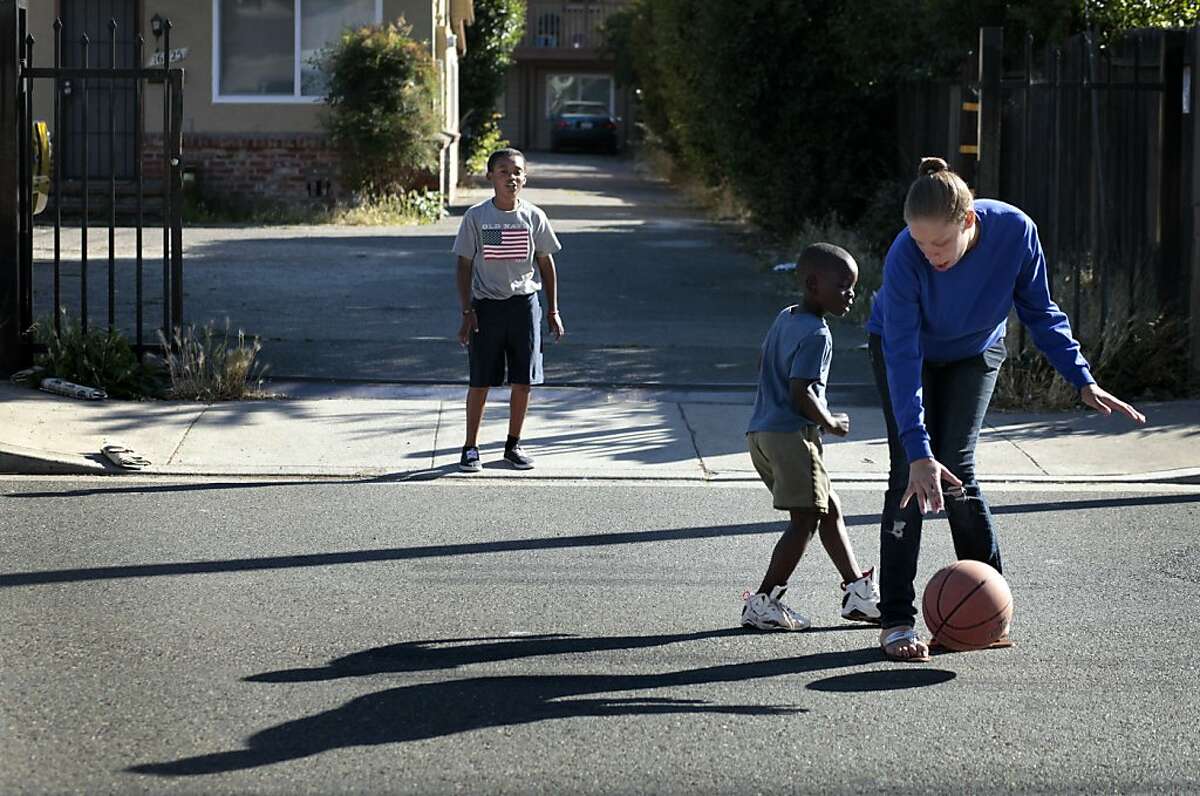 Brijjanna Price plays basketball with Shaun Brownwith, left, and  Kalem McCoy, Sunday June 3, 2012, near her grandmother's home in San Leandro, Calif. Photo: Lacy Atkins, The Chronicle