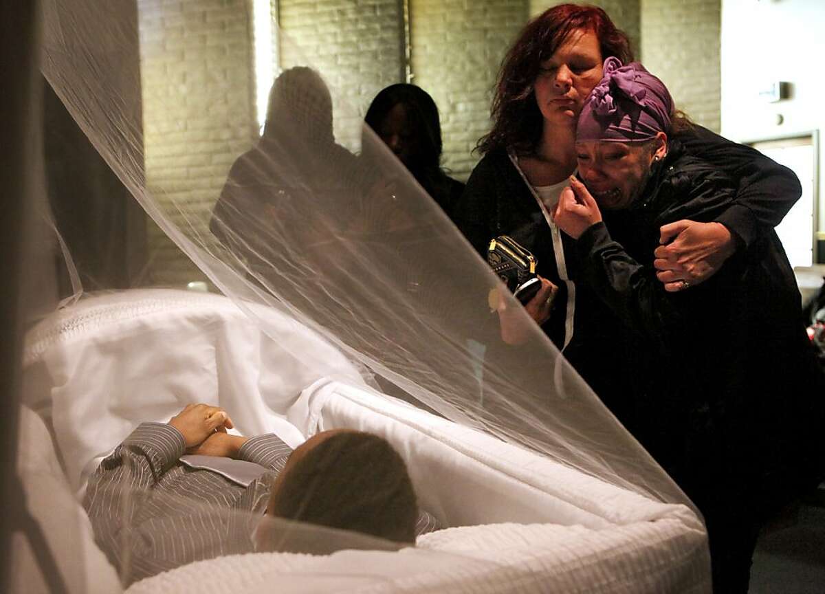 Sherri Miller, left , comforts Brijjanna Price, 16, as she sees her brother Lamont DeShawn Price, 17, in his coffin at the Whitted-Atkins Funeral Home, Wednesday Feb. 28, 2012, in Oakland, Calif. Lamont was shot and killed on Feb. 16, in the 8100 block of Birch St. Photo: Lacy Atkins, The Chronicle