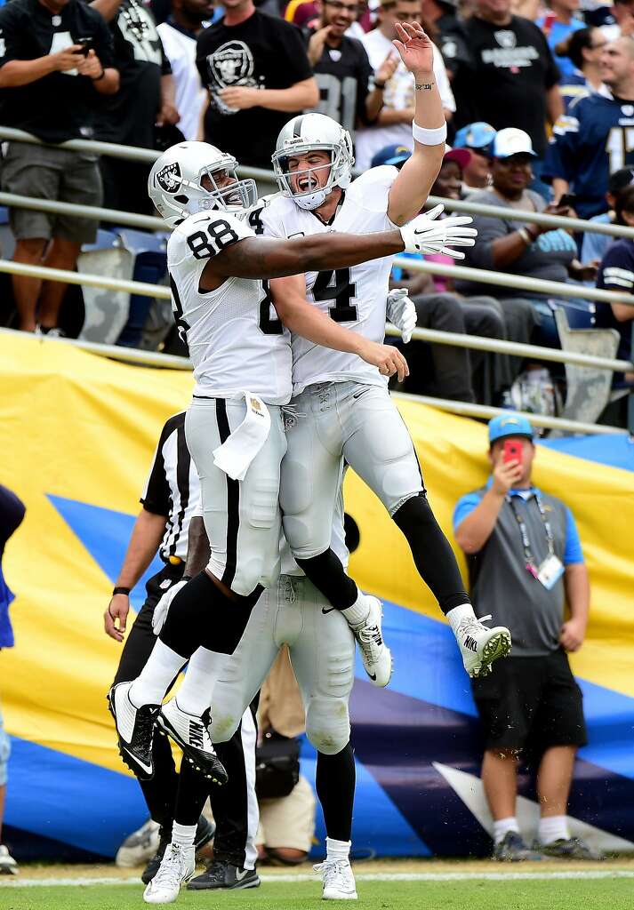 Oakland tight end Clive Walford (left) and quarterback Derek Carr get a jump on celebrating their touchdown connection. Photo: Harry How, Getty Images