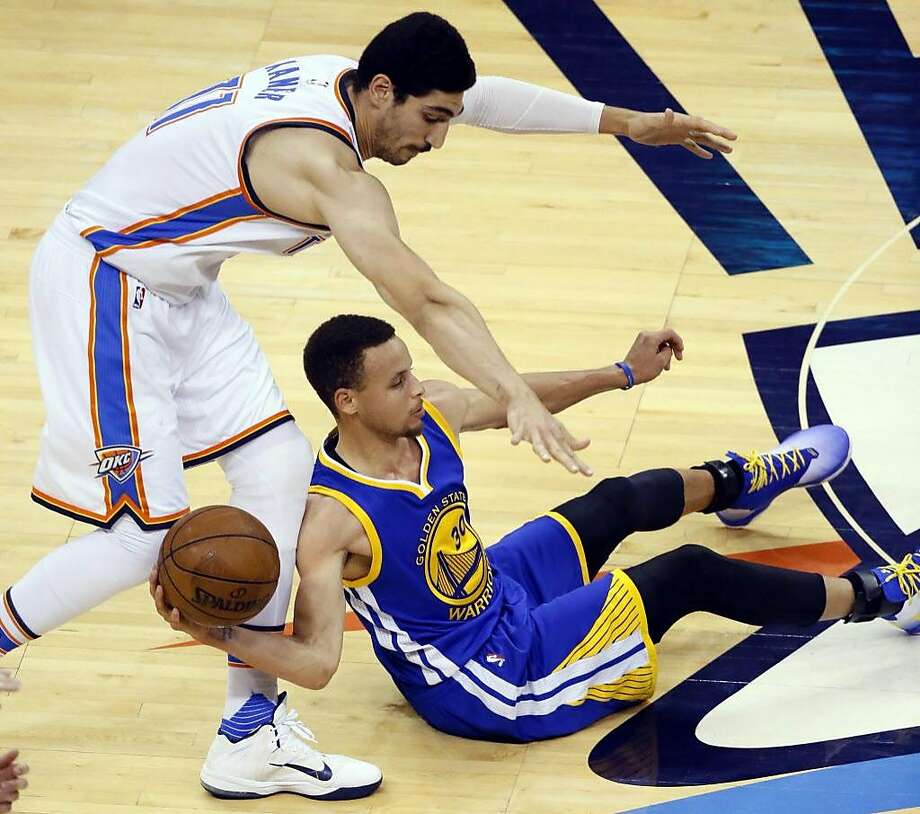 Golden State Warriors guard Stephen Curry (30) tries to pass a loose ball as Oklahoma City Thunder center Enes Kanter (11) defends in Game 4 of the NBA basketball Western Conference finals in Oklahoma City, Tuesday, May 24, 2016. (AP Photo/Sue Ogrocki) Photo: Sue Ogrocki, Associated Press