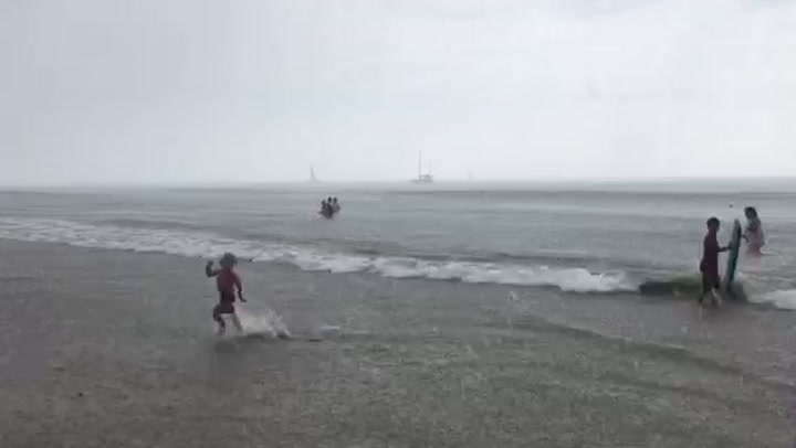 Weird microburst slams California beach town with rain, blows over umbrellas
