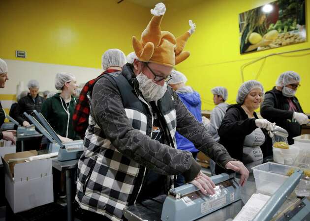 Food Bank volunteers offer their Thanksgiving holiday to feed the hungry