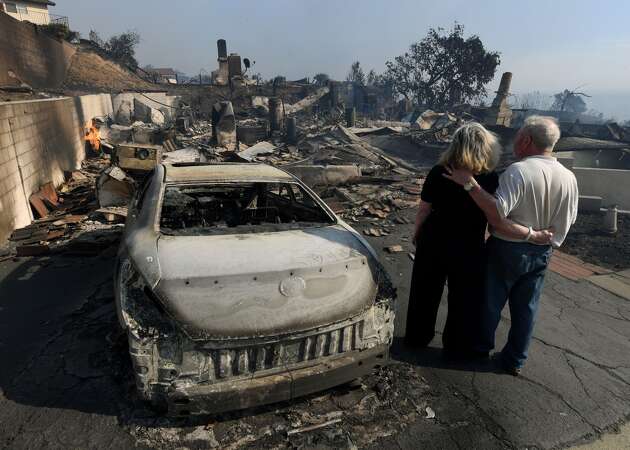 Southern California wildfires burn homes, close freeways as thousands evacuated